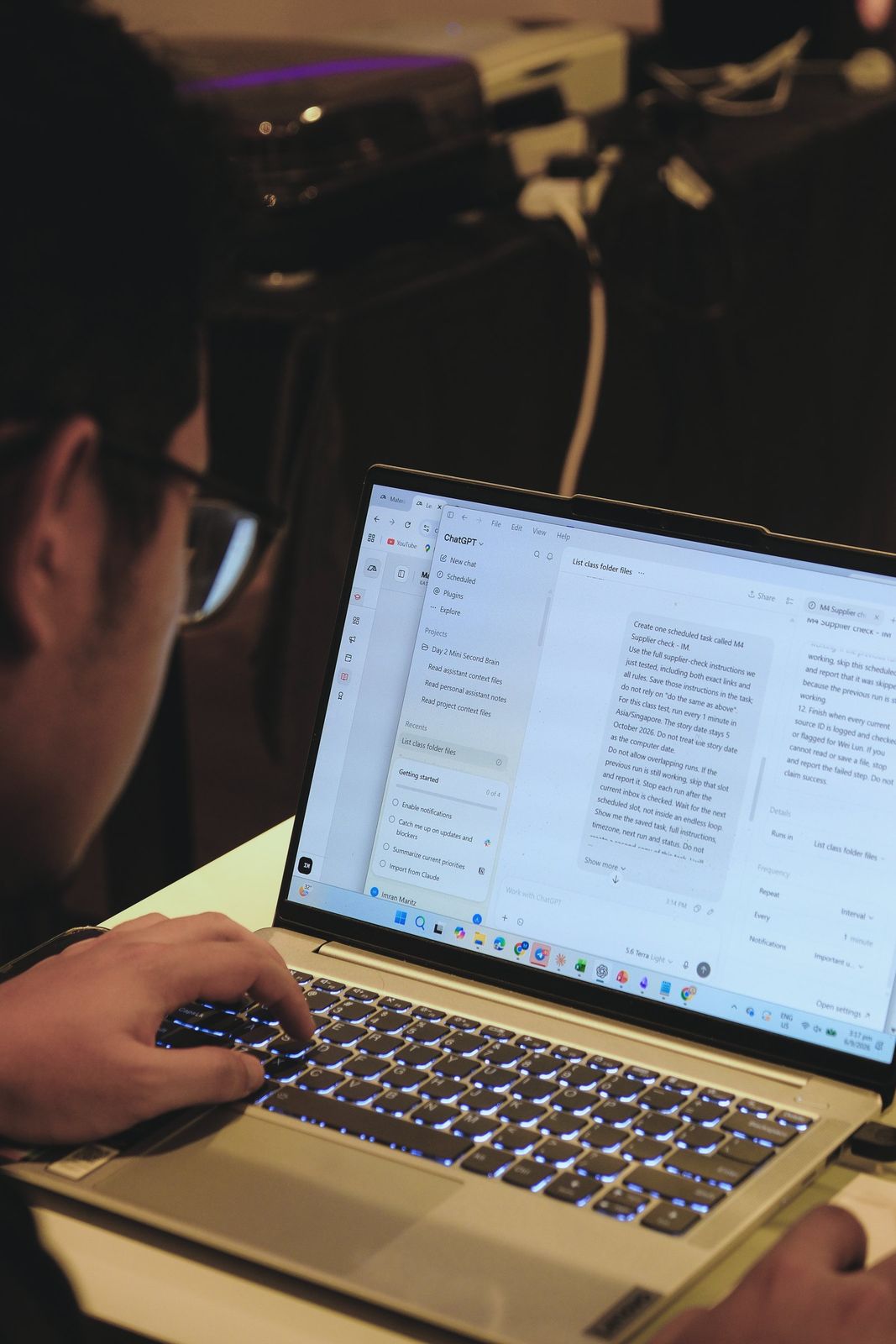 A learner working through an AI chat on a laptop
