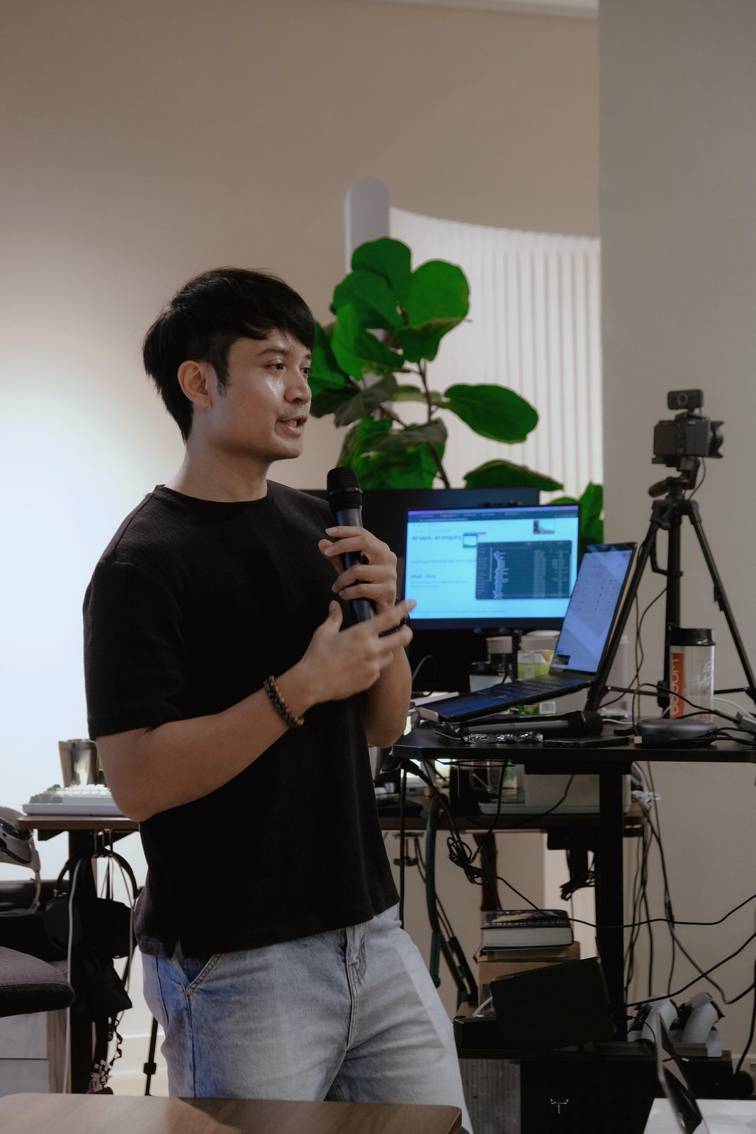 An instructor speaking to the class with a microphone