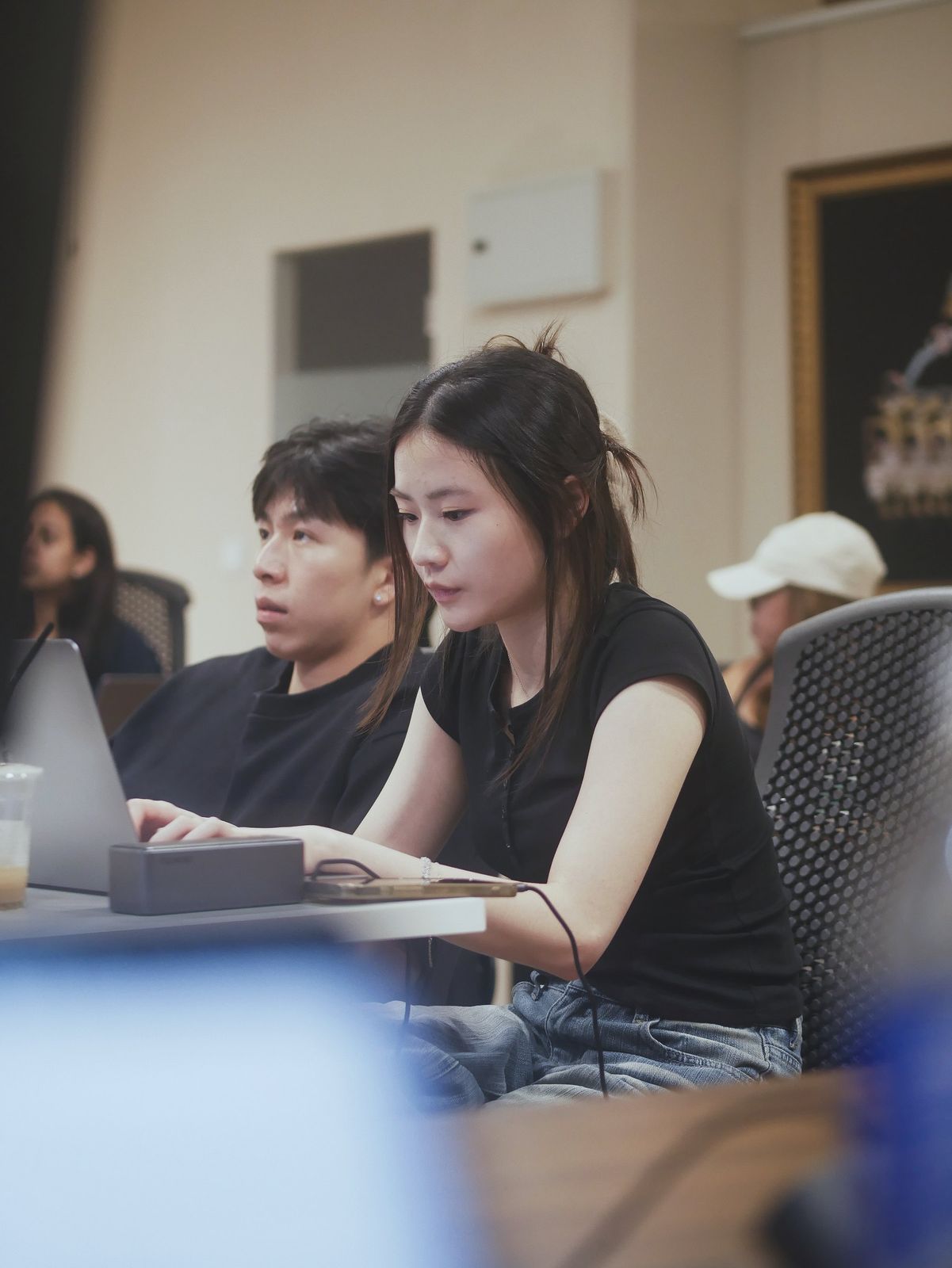 Two learners working side by side at their laptops